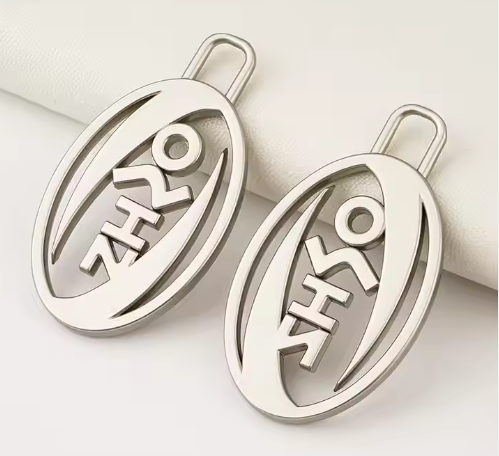 How does the engraved round metal logo detect if the paint is falling off?-B